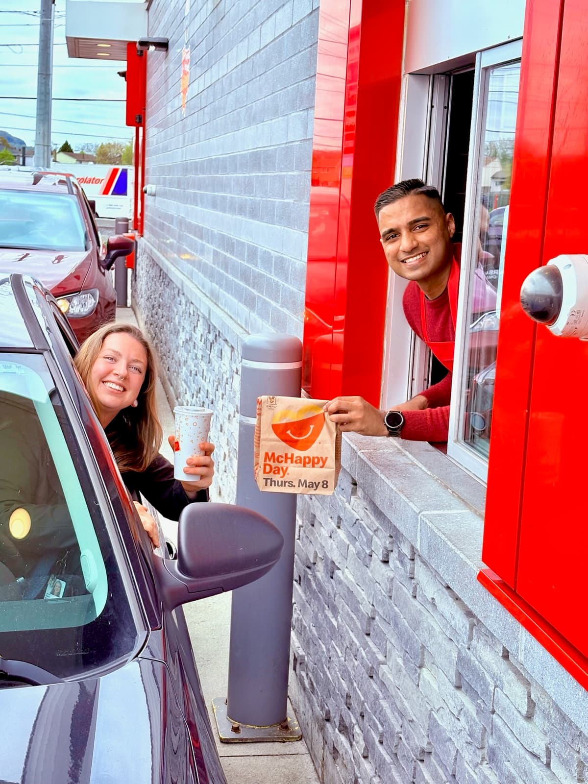 Adil Khalqi serving at a McHappy Day fundraiser in Milton